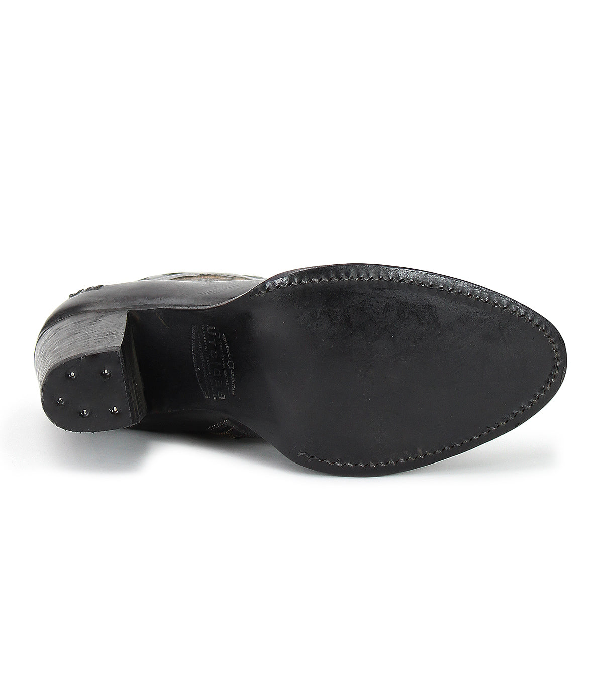 The image displays the underside of the Bed|Stü Yuno black leather dress shoe, featuring visible stitching around the sole, small metal studs on the heel, and subtle contrast leather accents that elevate its sophisticated design.