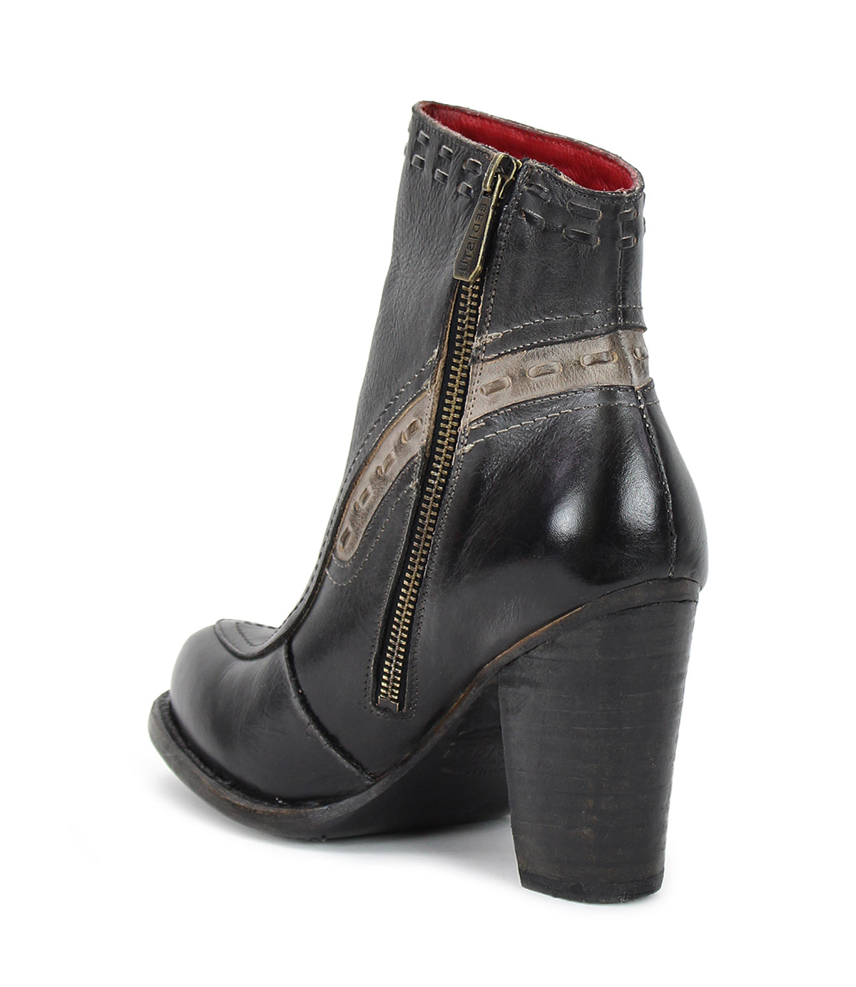 Introducing the Yuno by Bed|Stü—a black leather heeled ankle boot featuring a side zipper, decorative stitching, beige contrast leather accents, and a red interior lining, designed with breathable cushioning for comfort and shown from a back side angle.