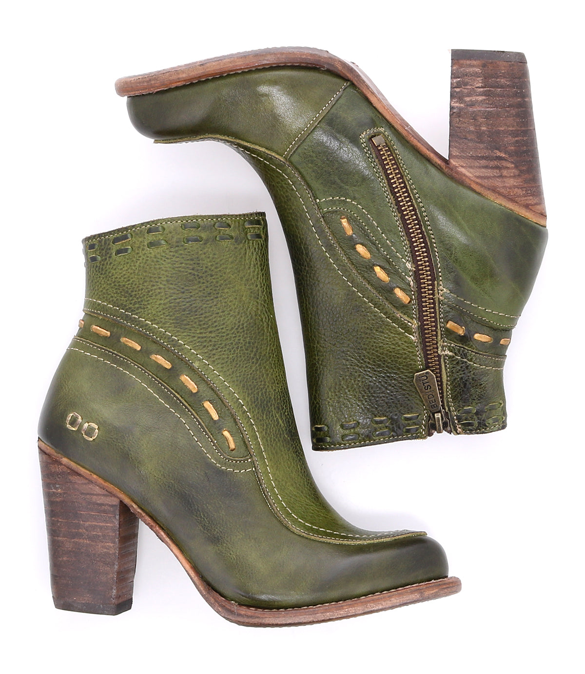 The Yuno ankle boots by Bed|Stü feature green leather uppers, brown wooden heels, decorative stitching, contrasting leather accents, convenient side zippers, and a subtle metallic logo on the heel area. Displayed against a white background.