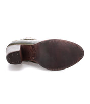 The image displays the sole of the Bed|Stü Yuno leather dress shoe, which features a dark brown finish, visible edge stitching, and small heel nails. Subtle contrasting leather accents add sophistication to its classic design.