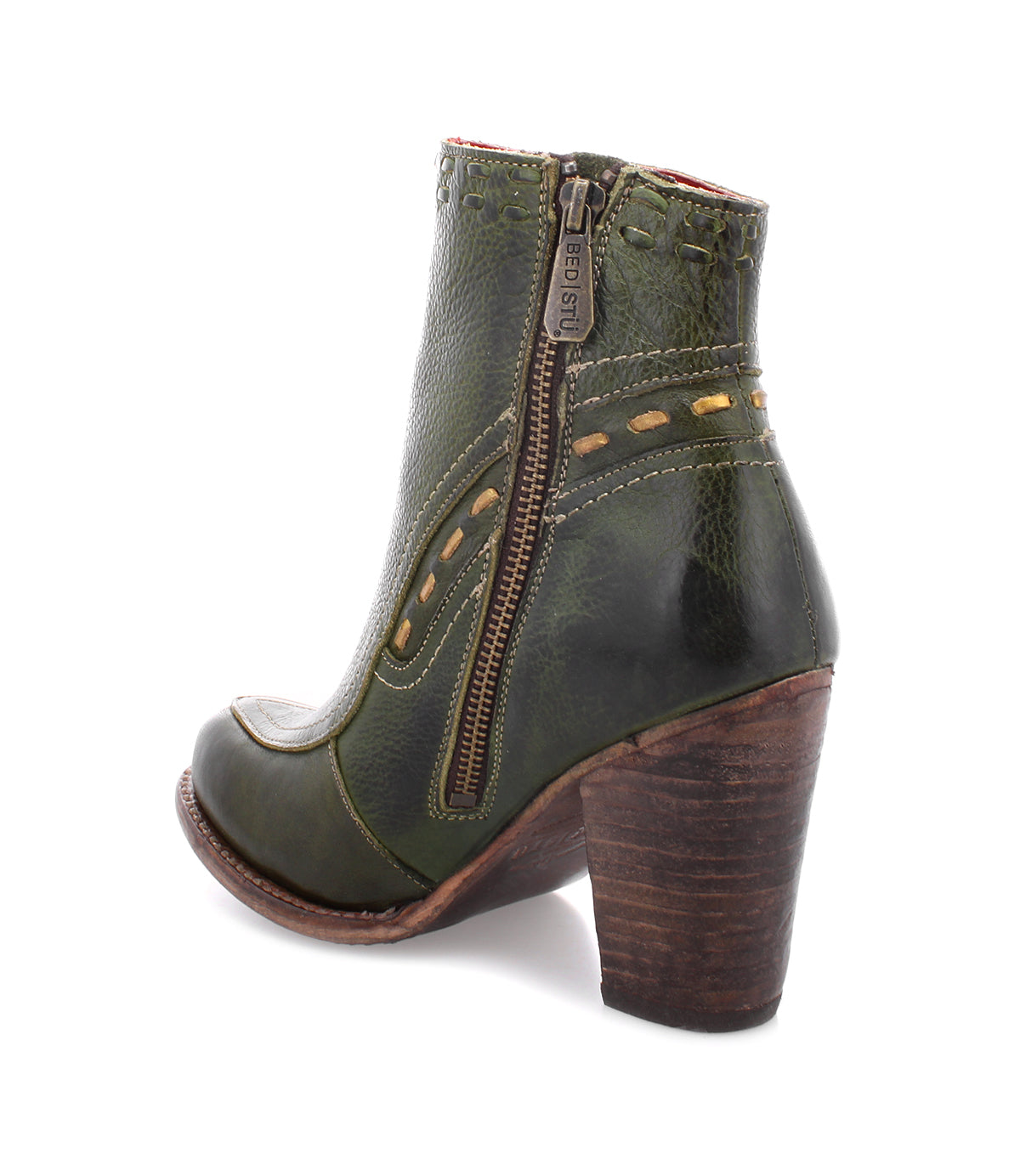 Sure! Here’s a rewritten version using your product data: The Yuno ankle boot by Bed|Stü features green leather with decorative stitching, contrast leather accents, a side zipper, and a thick brown stacked heel for a stylish finish. This elevated heel boot is showcased against a plain white background.