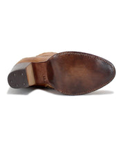 The image shows the underside of the Bed|Stü Yuno, a brown leather dress shoe featuring a pointed toe, a wooden heel, and contrasting leather accents.