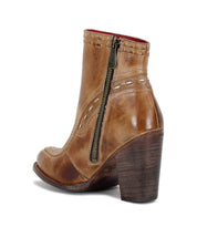 Bed|Stü Yuno brown leather ankle boot featuring a side zipper, decorative stitching, contrasting leather accents, and a chunky stacked elevated heel, shown from the back.