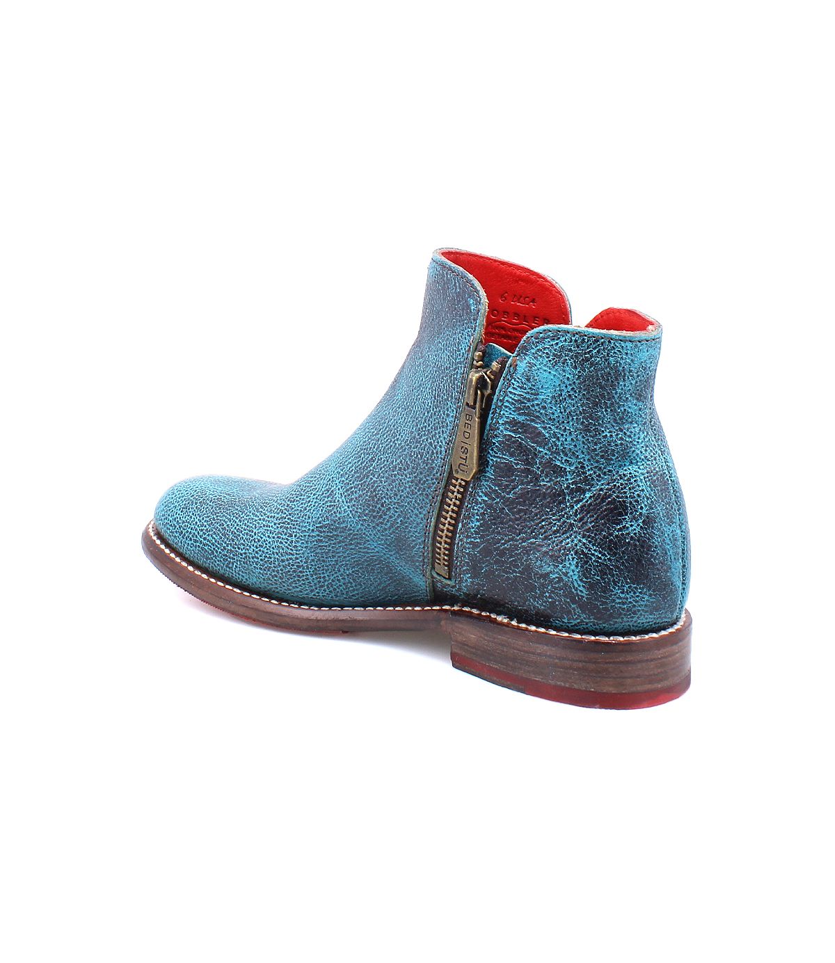 The Yurisa ankle boot by Bed|Stü features handcrafted turquoise leather, a side zipper, red interior lining, and a brown stacked heel, shown angled to the side.