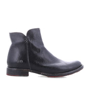 The Yurisa ankle boot by Bed|Stü features handcrafted black leather, a rounded toe, low heel, and visible stitching detail, shown from the side against a white background.