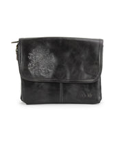 Discover the Ziggy JB by Bed|Stü—a black leather crossbody bag featuring a front flap, subtle embossed floral design, and simple stitching details. It’s the ideal choice for anyone looking for a sleek alternative to a traditional clutch.