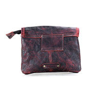The Ziggy by Bed|Stü is a compact, rectangular pouch in black and red supple leather, featuring a flap closure, metal rivet accents, and a short side zipper pull tab.
