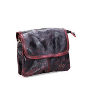 Introducing Ziggy by Bed|Stü—a supple, dark brown leather shoulder bag featuring a flap closure and distinctive red stitching, beautifully showcased against a white background. This versatile crossbody from Bed|Stü effortlessly blends style and functionality, making it perfect for everyday use.